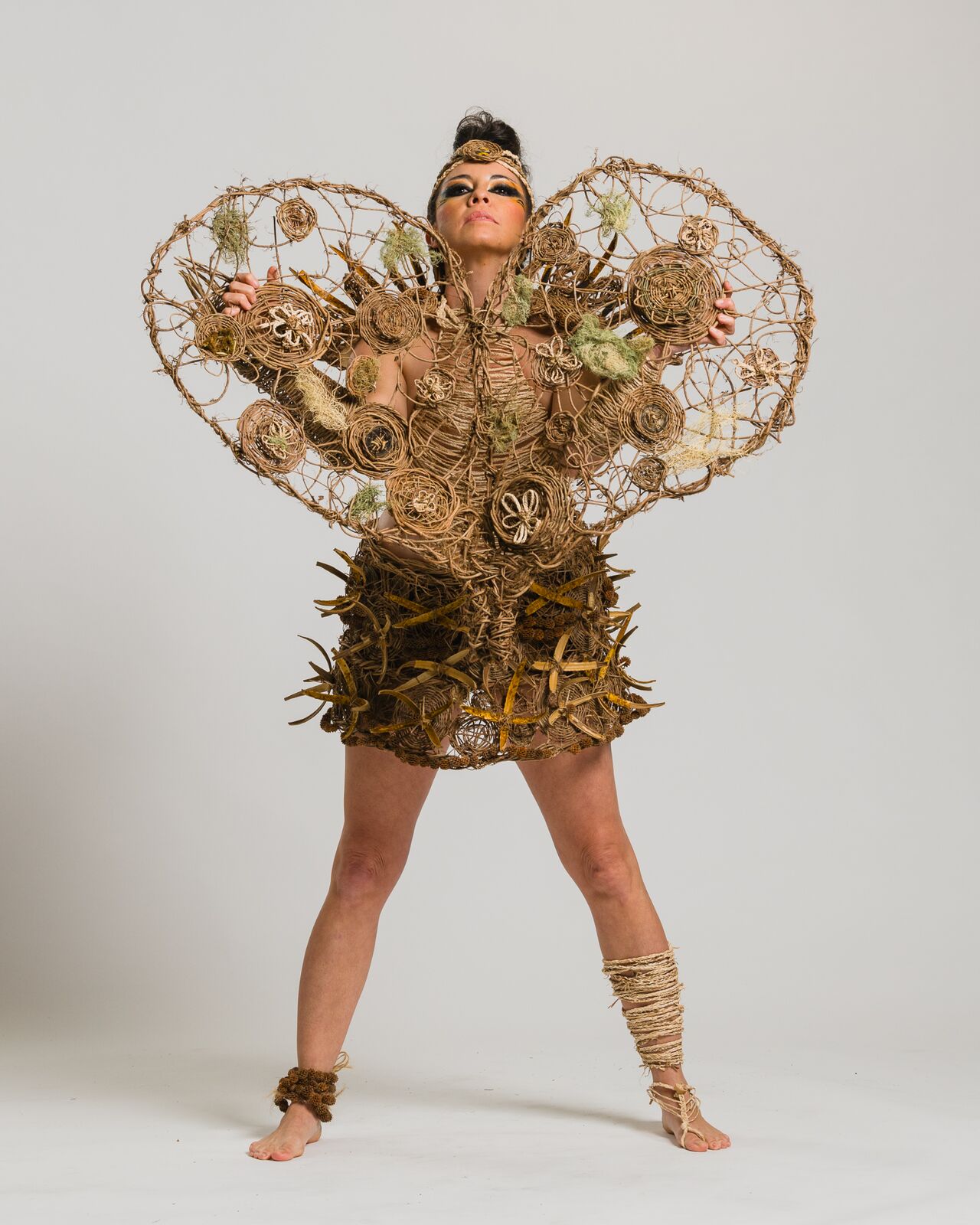 Alpha in a woven wearable art costume with wings
